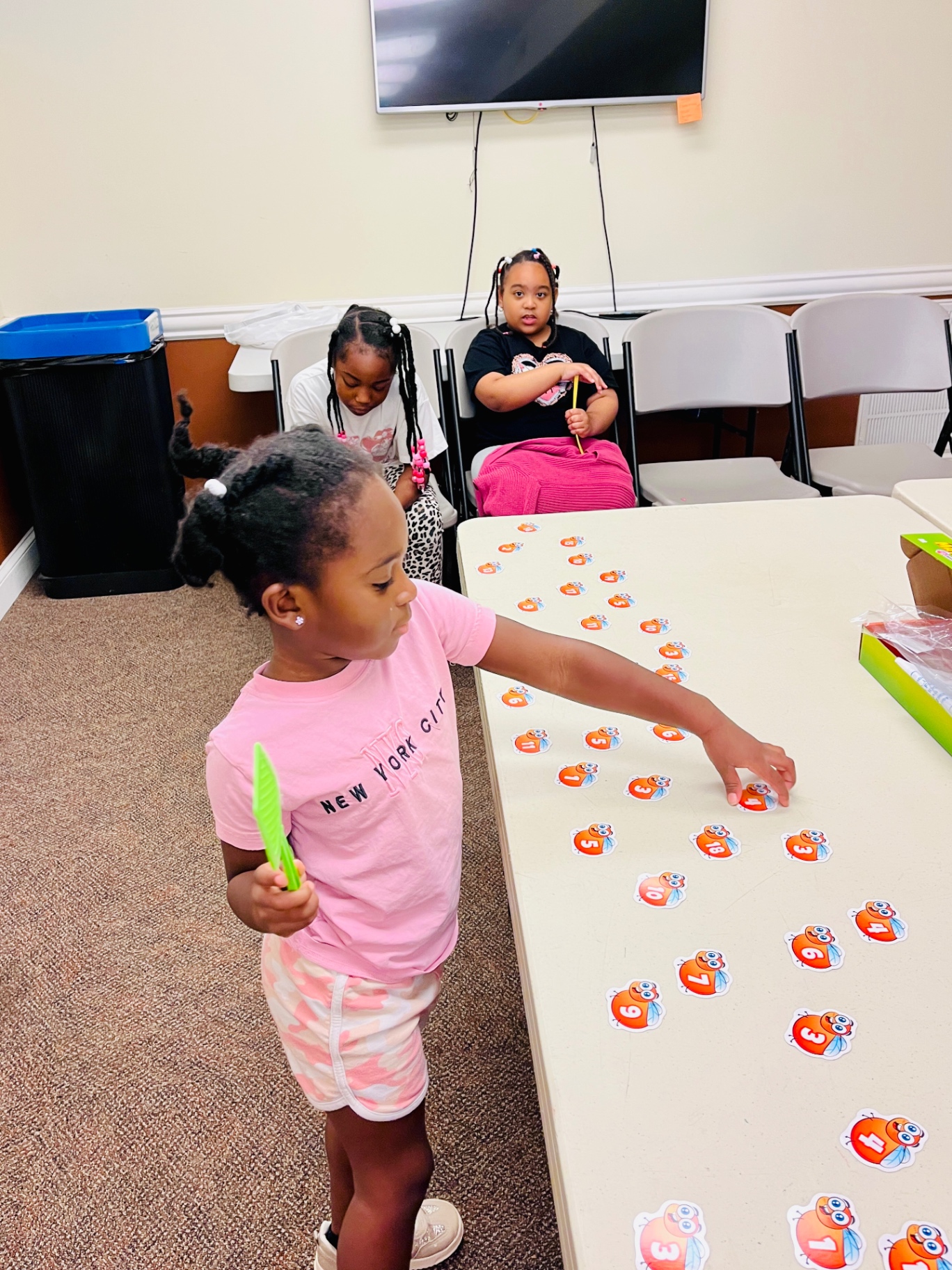 Students practicing number recognition with a matching game